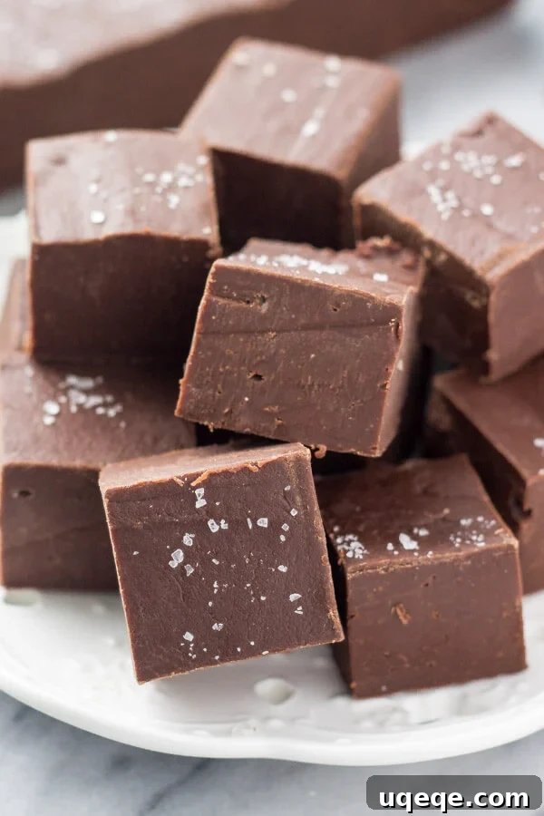 Effortless Homemade Fudge 4 A bowl of chocolate, condensed milk, and butter partially melted in the microwave, being stirred to combine.