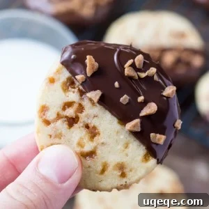 Soft, buttery, melt-in-your-mouth sugar cookies with golden edges. Filled with toffee pieces & dipped in chocolate - these toffee icebox cookies are just that incredible.