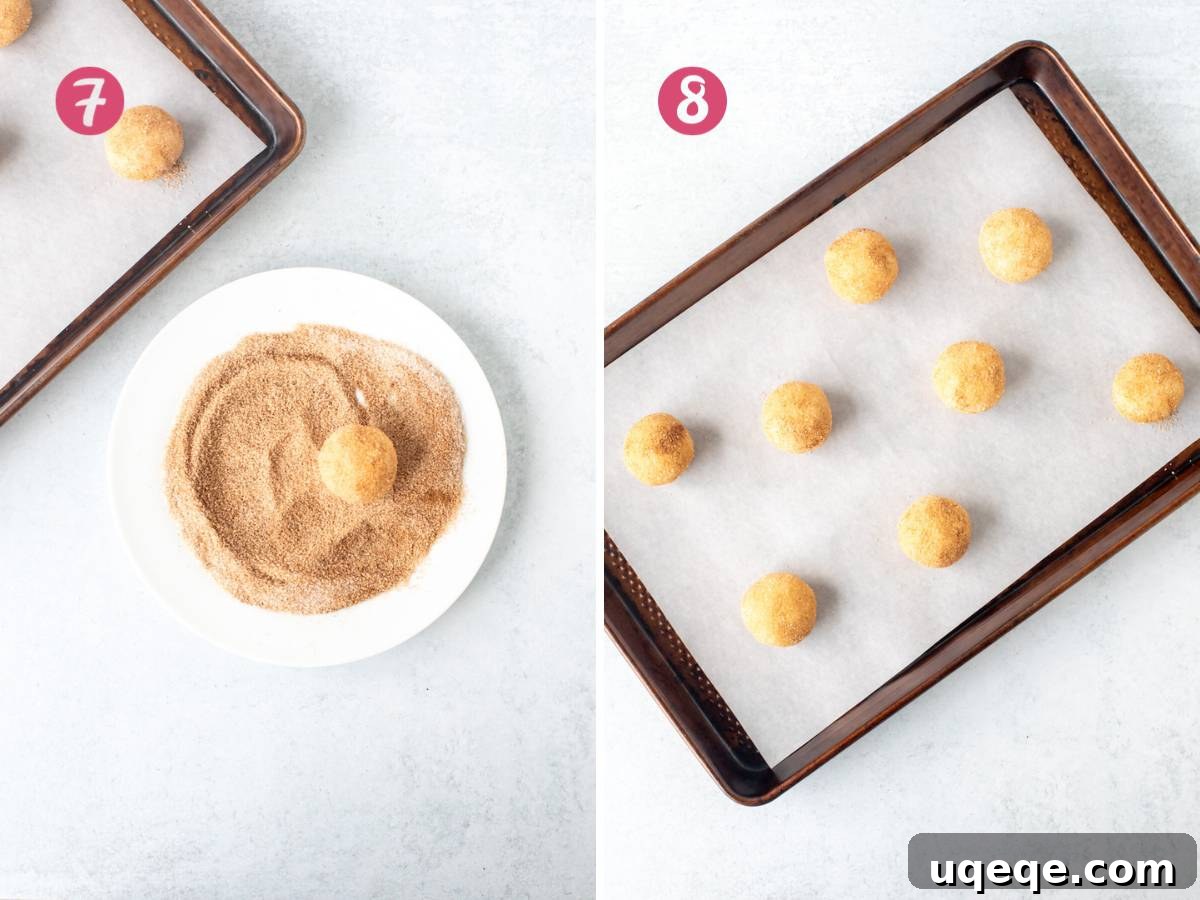 Scooped snickerdoodle cookie dough balls, coated in cinnamon sugar and placed on a baking sheet
