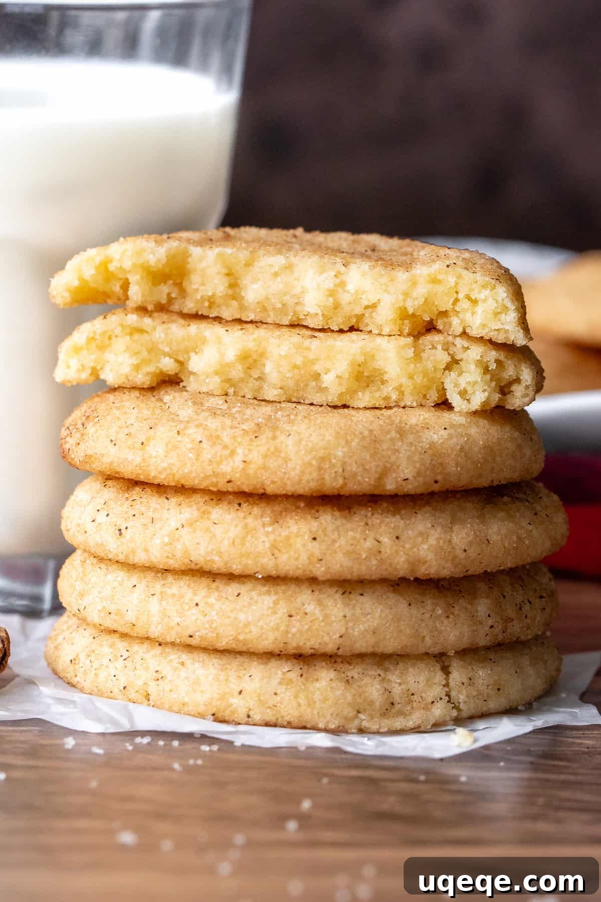 Perfectly Chewy Snickerdoodle Cookies 9 Stack of snickerdoodles with the top cookie broken in half, beside a glass of milk