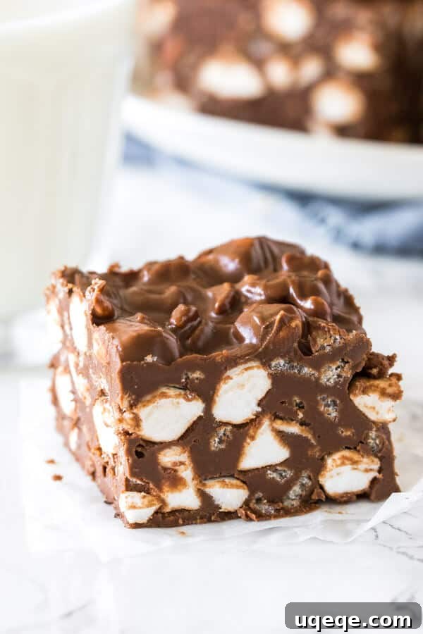 Effortless Rocky Road Delights 3 A no bake rocky road bar with a glass of milk, highlighting its delicious texture.