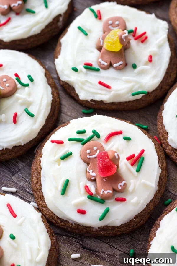 Frosted gingerbread cookies decorated with festive sprinkles and small gumdrop gingerbread men, ready for a holiday feast.