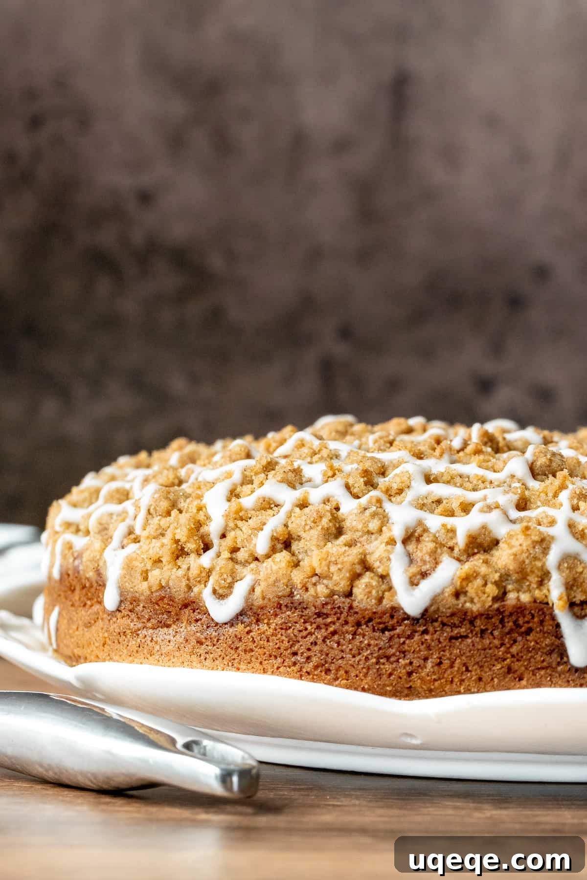 Beautifully baked 9-inch round banana coffee cake, ready for slicing, showcasing its golden streusel topping