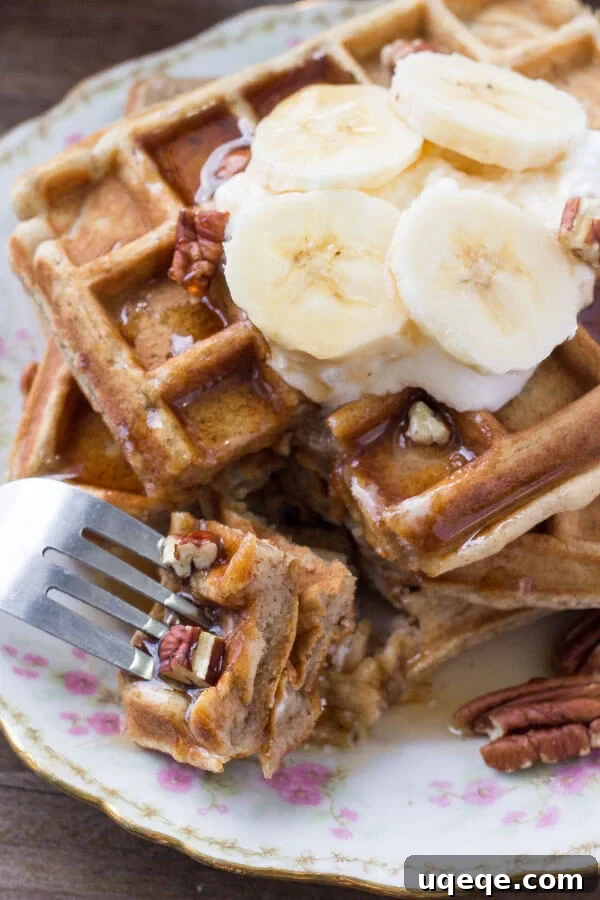 Banana Bread Bliss Waffles: Fluffy, Fragrant, and Cinnamony 5 A close-up image showing a bite taken out of a fluffy banana bread waffle, revealing its soft, airy texture and golden interior.