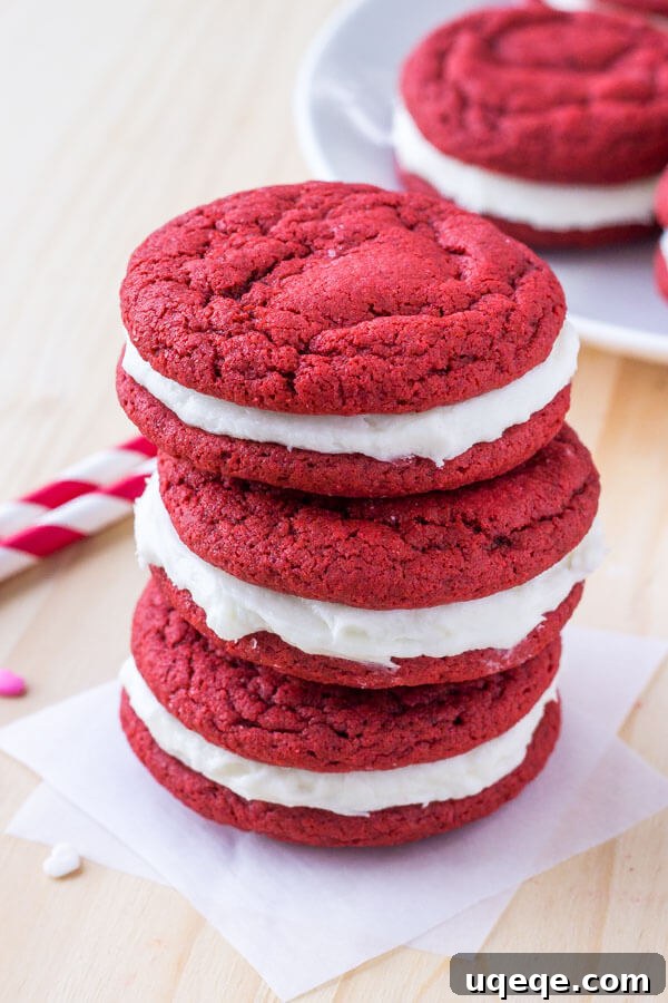 Velvet Crimson Delights 5 A stack of beautifully assembled homemade red velvet sandwich cookies, filled with luscious cream cheese frosting, ready to be enjoyed.