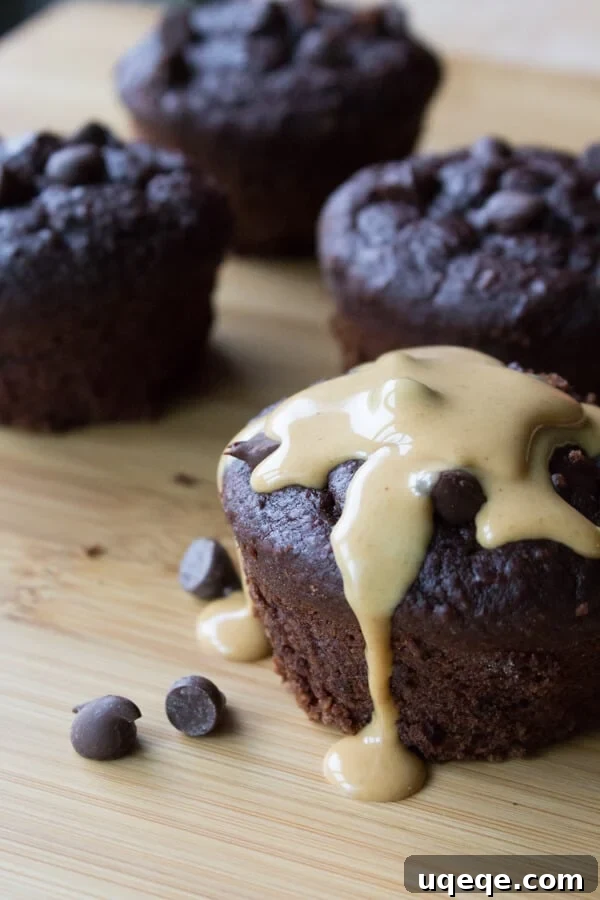 Delightfully Guiltless Double Chocolate Muffins 3 Close-up of freshly baked Guilt-Free Double Chocolate Muffins cooling on a wire rack. They are wholesome, natural, flourless, dairy-free, with no refined sugars or butter/oil.