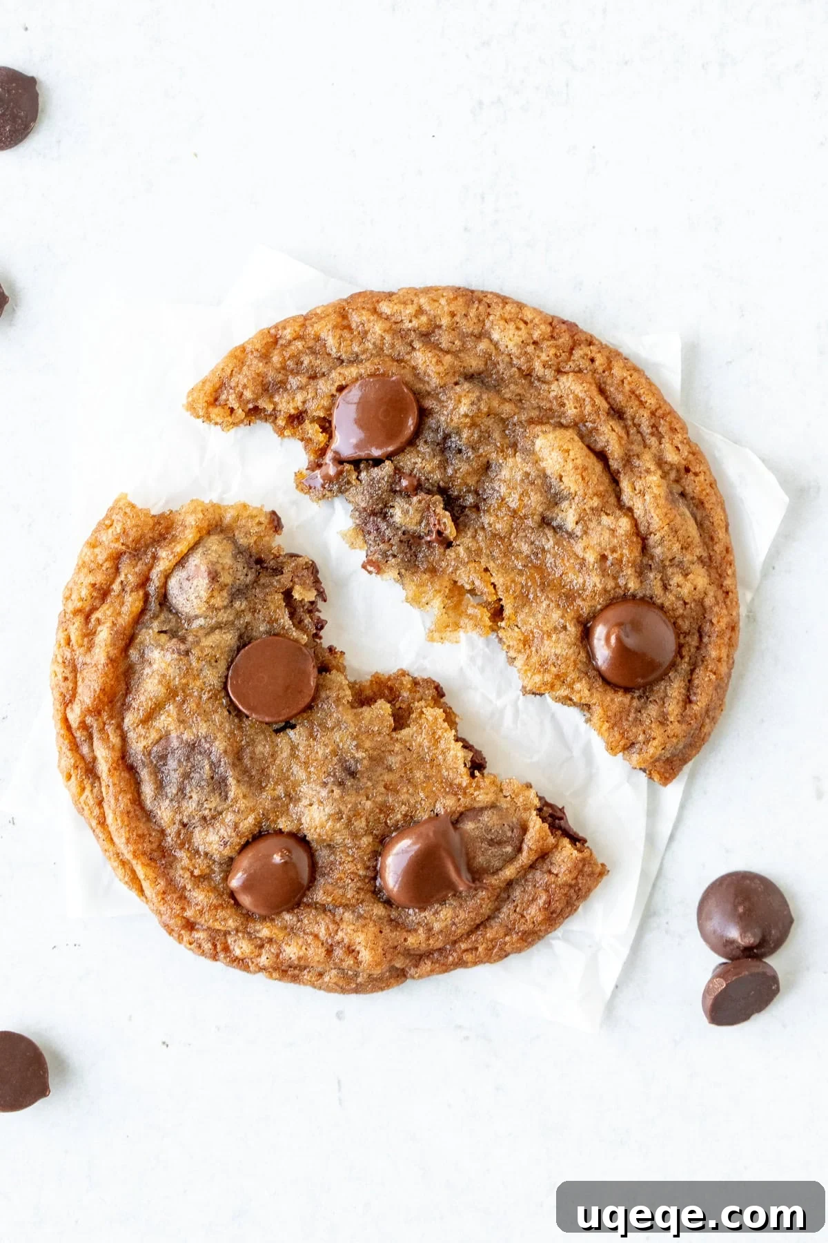 Banana Bliss Choc-Chip Cookies 2 Soft and gooey banana chocolate chip cookie, broken in half to reveal melted chocolate chips