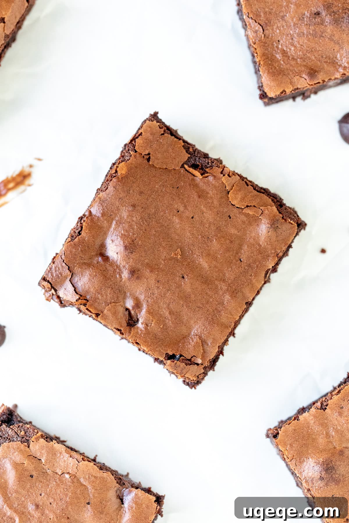 Chocoholic's Dream Brownies 3 Close-up of a triple chocolate brownie showing its distinctive crinkly and shiny top surface.