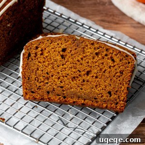 Close-up of a slice of pumpkin bread with cream cheese glaze