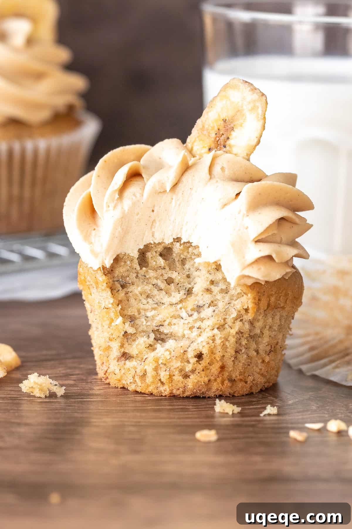 Peanut Butter Banana Dream Cupcakes 4 Cupcake topped with frosting and a banana chip with a bite taken out