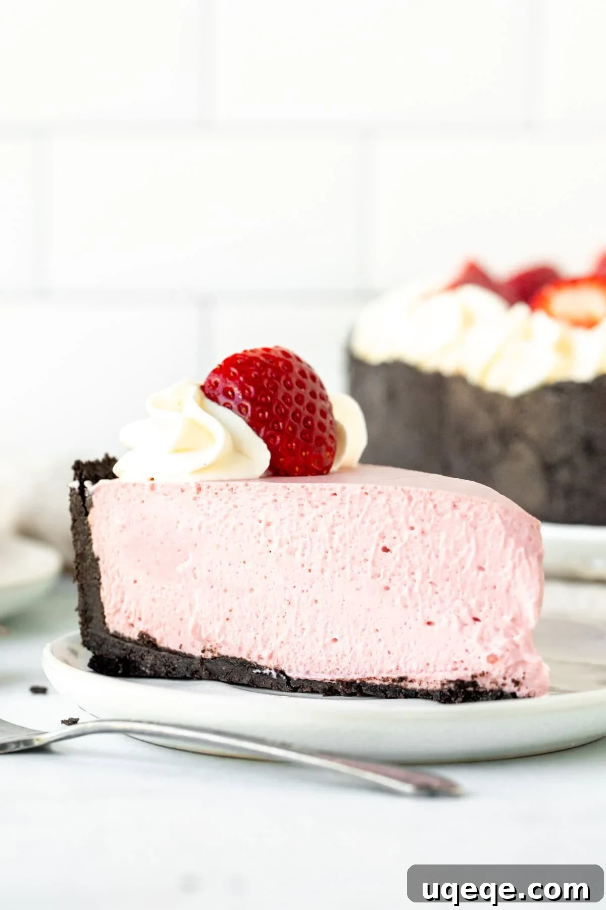 Velvet Strawberry Cheesecake 2 Slice of no bake strawberry cheesecake topped with whipped cream and a strawberry