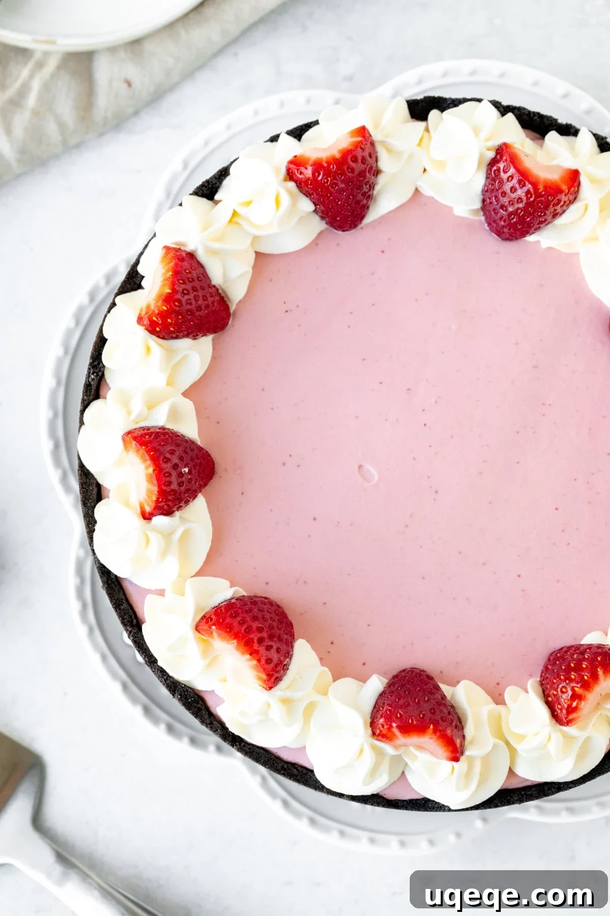 Velvet Strawberry Cheesecake 3 9-inch round strawberry cheesecake topped with whipped cream and berries around the edges