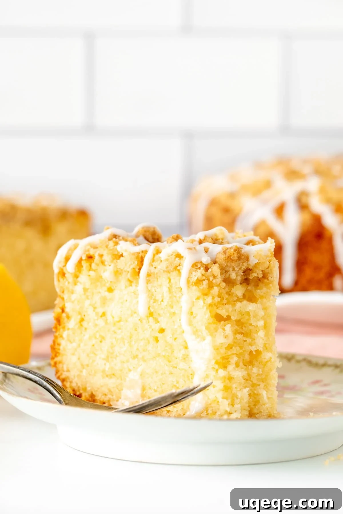 Zesty Lemon Coffee Cake 10 Slice of lemon coffee cake with crumb topping with a bite taken out