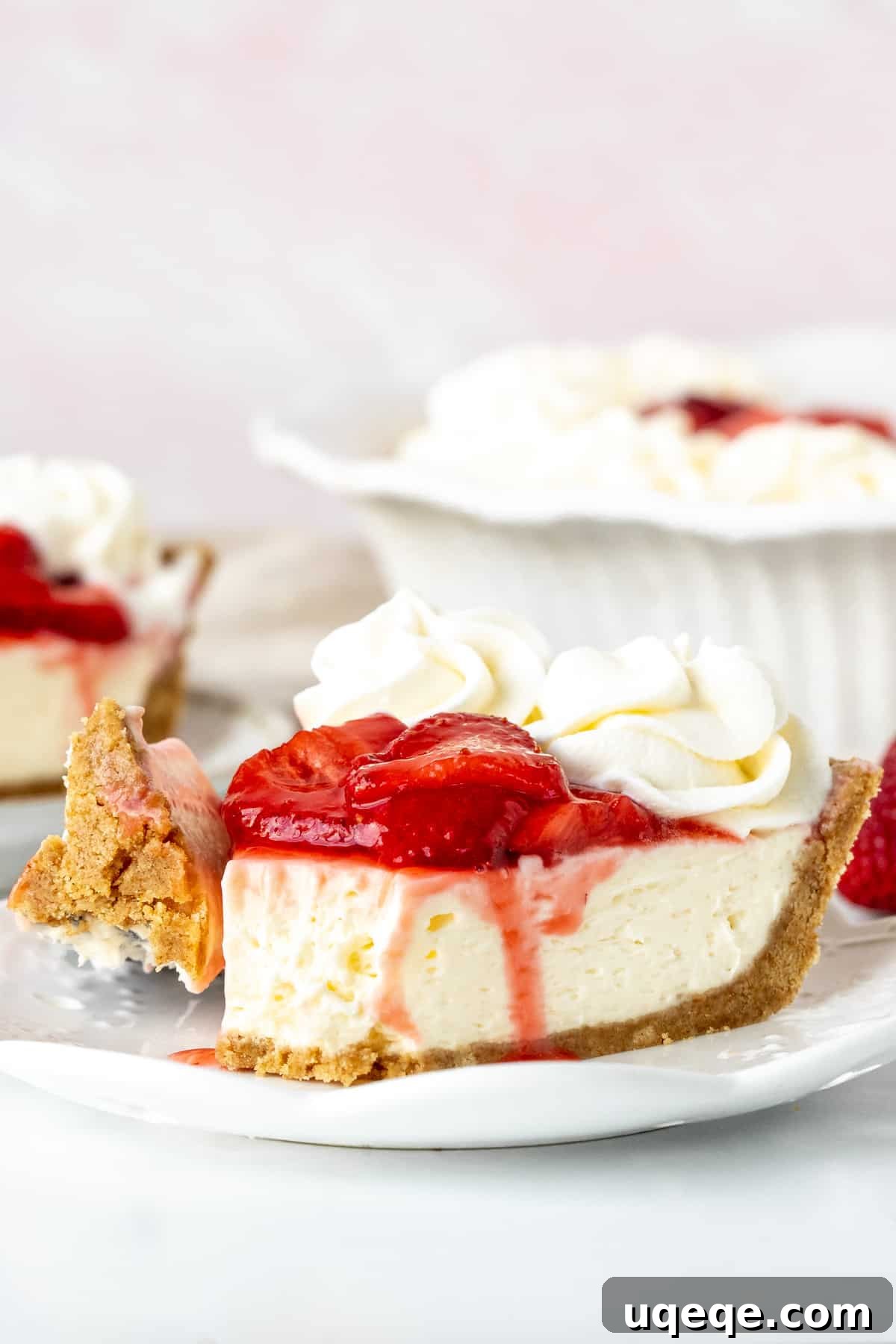 Strawberry Dream Cheesecake 9 Slice of strawberry cream cheese pie, with bite taken out