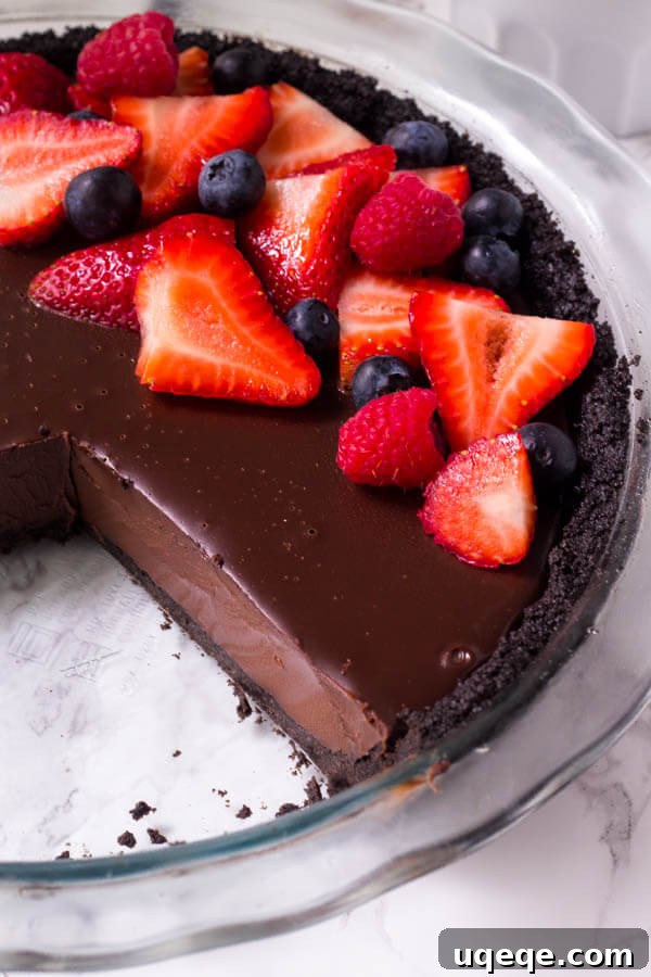 No bake chocolate pie has a delicious Oreo crust and rich chocolate fudge filling for the ultimate chocolate pie recipe.