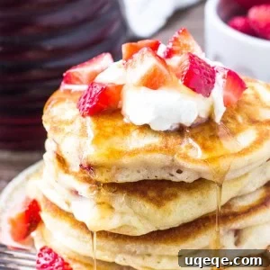 These extra fluffy strawberry pancakes have golden edges and are filled with juicy berries in every bite. An easy, delicious breakfast recipe.