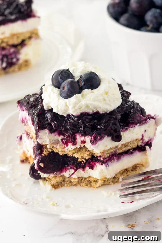 Blueberry Cheesecake Icebox Cake. Layers of graham crackers, creamy no bake cheesecake, and blueberry pie filling.