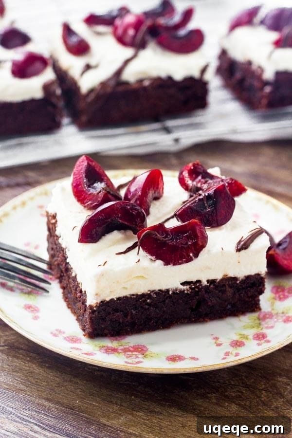 Extra fudgy brownies topped with whipped cream & cherries - these black forest brownies are so easy & delicious. 