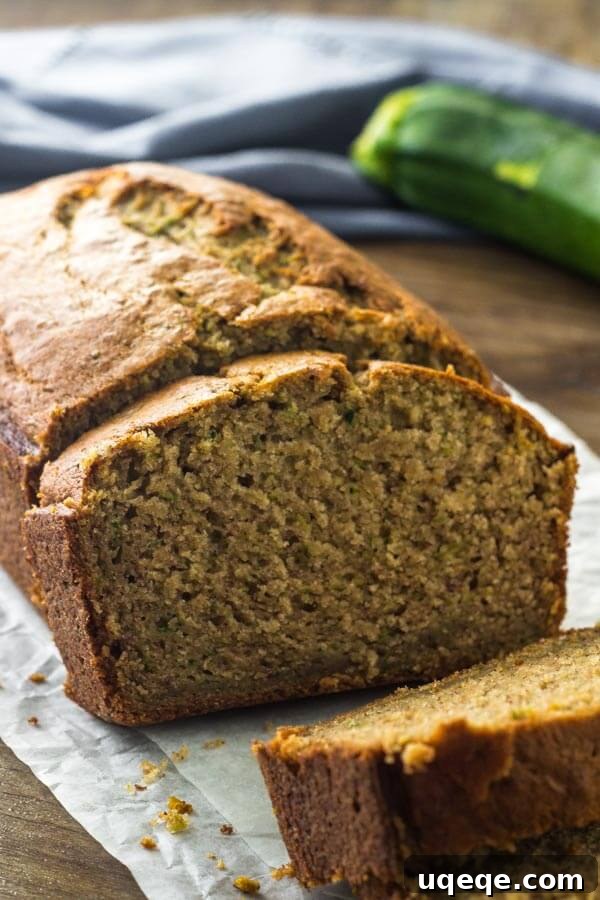 Sliced Zucchini Banana Bread on a cooling rack with a golden brown top, showcasing its moist texture.