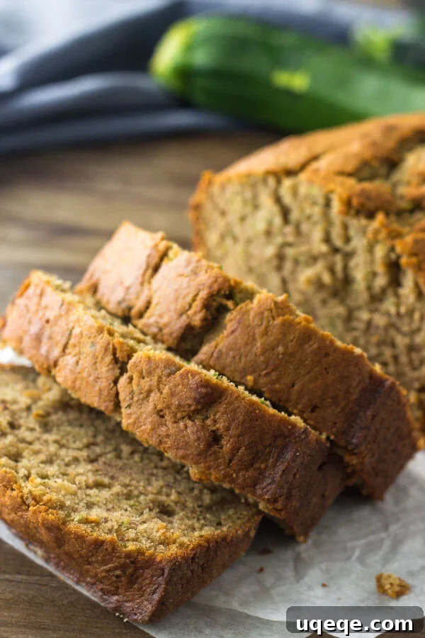 Garden Fresh Zucchini Banana Loaf 3 Close up shot of slices of zucchini banana bread with a perfectly golden brown top, showing its rich texture.