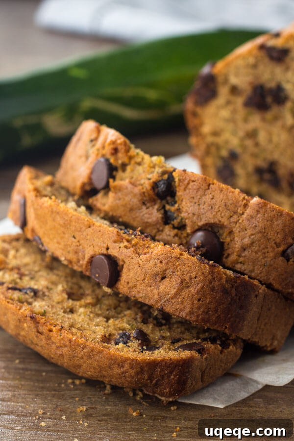 Decadent Chocolate Chip Zucchini Loaf 5 A perfectly baked chocolate chip zucchini bread cooling on a wire rack, featuring a delightful domed top and golden-brown crust.