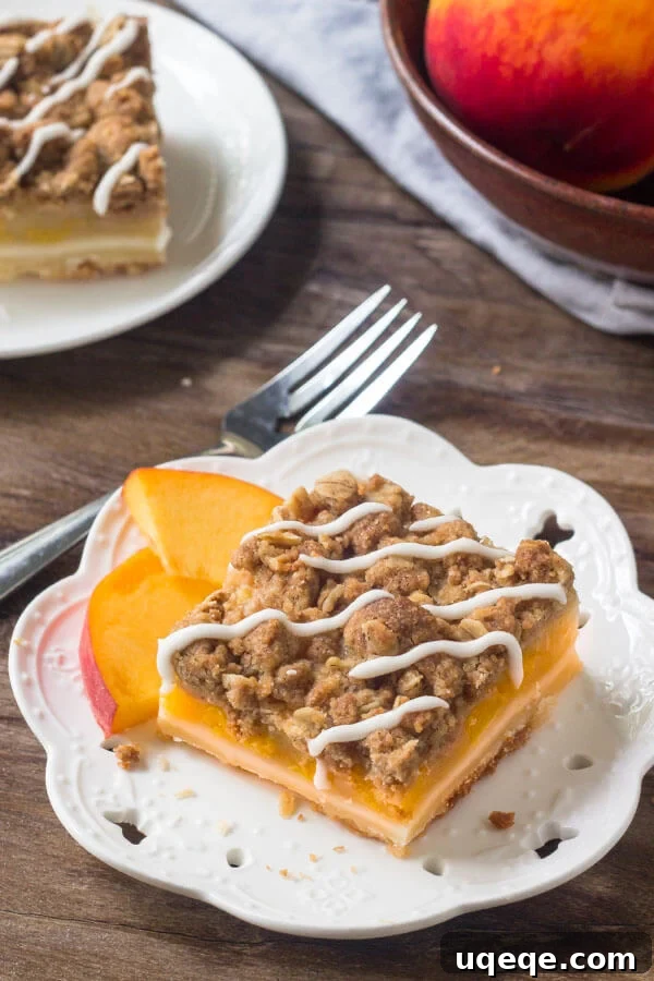 Peachy Crumble Bars 2 Peach Pie Crumble Bars, showing a cross-section with a golden shortbread base, vibrant peach filling, and a rustic oatmeal crumble topping, drizzled with a sweet vanilla glaze.