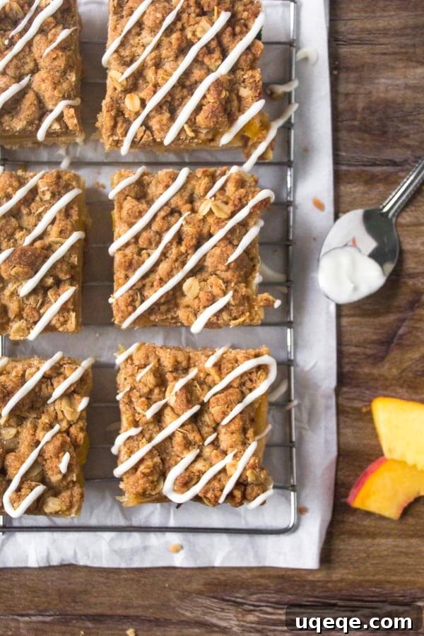 Peachy Crumble Bars 4 Several neatly cut Peach Crumble Bars arranged on a rustic wooden board, showcasing their golden-brown topping, juicy peach filling, and sturdy shortbread base.