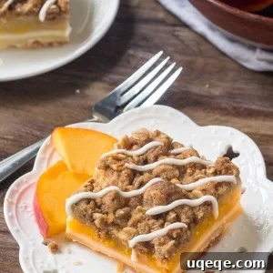 Peach Pie Crumble Bars have a buttery shortbread base, a layer of juicy peaches, & crunchy oatmeal crumble topping