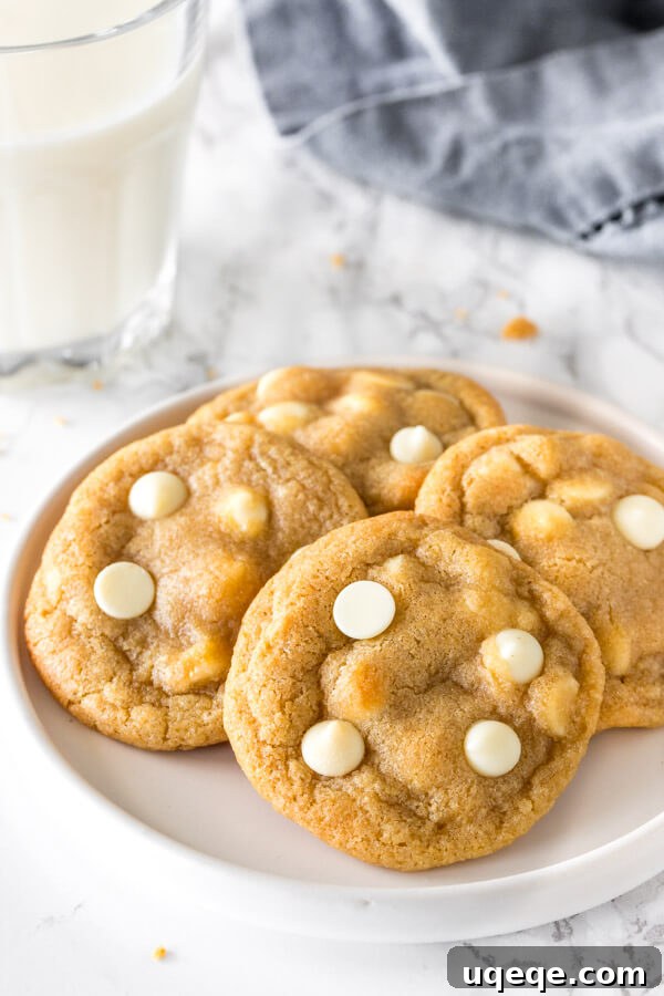 Decadent White Chocolate Chip Cookies 2 A beautifully arranged plate of freshly baked, chewy white chocolate chip cookies, showcasing their soft, golden-brown texture and an abundance of melted white chocolate chips. Perfect for sharing or enjoying solo!