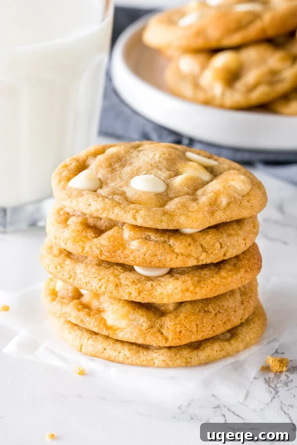 Decadent White Chocolate Chip Cookies 3 A stack of perfectly baked white chocolate chip cookies, highlighting their golden edges, soft centers, and generous distribution of white chocolate throughout each cookie.