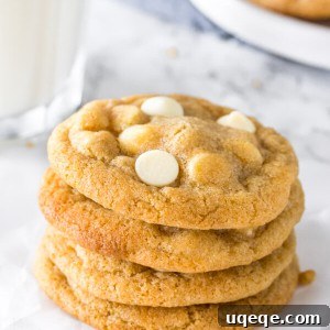 Decadent White Chocolate Chip Cookies 6 A stack of golden-brown white chocolate chip cookies with visible chocolate chips, perfectly baked and ready to be devoured.
