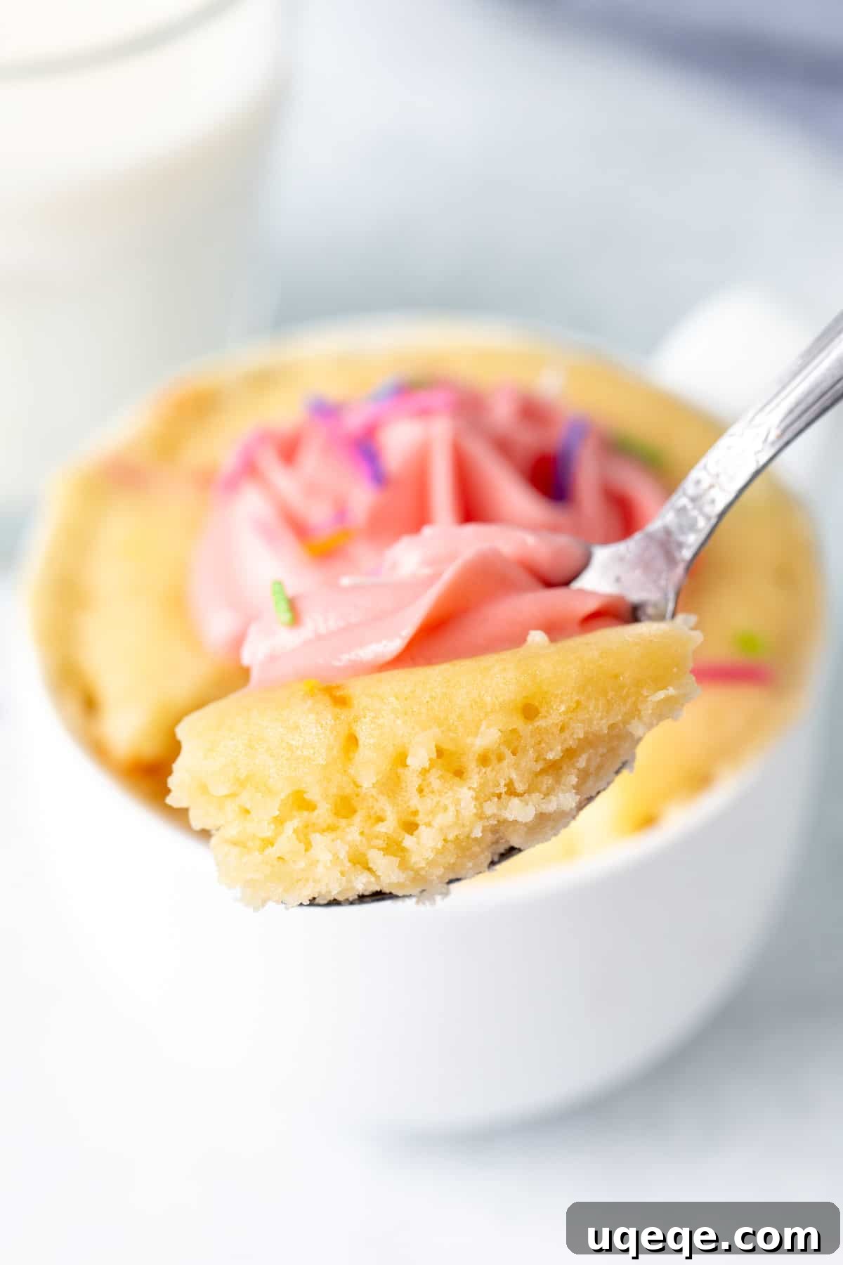 Easy Vanilla Mug Cake 8 Spoon with a scoop of vanilla cake made in a mug