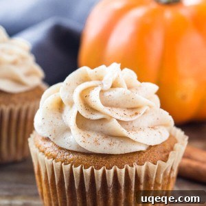 Moist pumpkin cupcakes topped with rich cinnamon cream cheese frosting, perfect for fall.