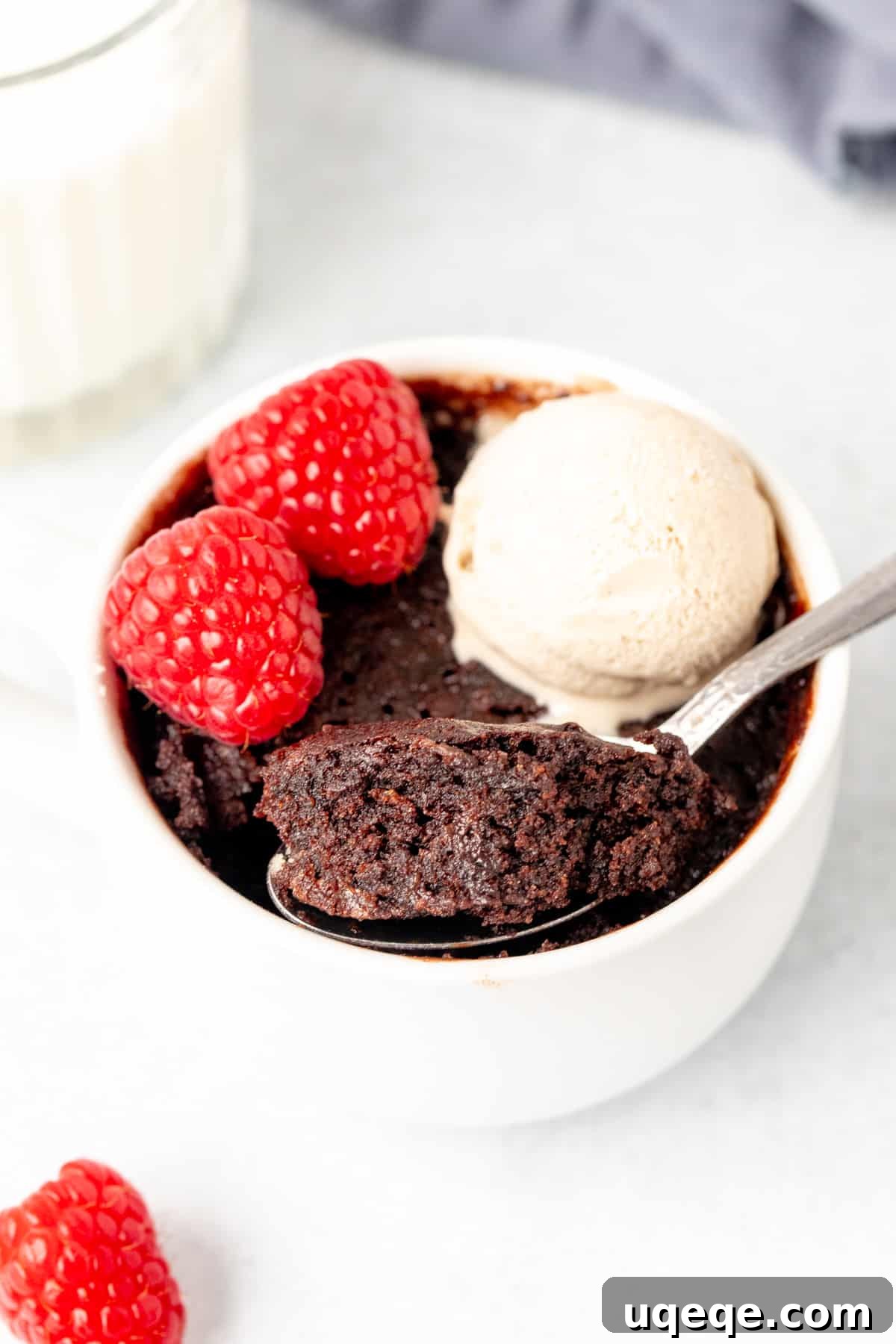 Fudgy Chocolate Mug Treat 6 Close-up of a chocolate mug cake with a spoon scooping out a bite, revealing its moist and fudgy interior.
