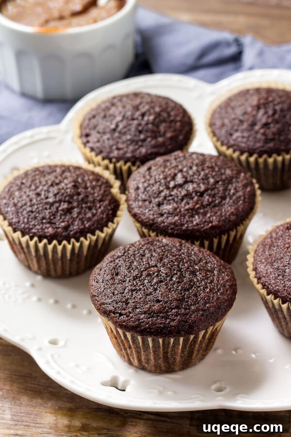 Decadent Chocolate Caramel Cupcakes 4 A plate featuring several moist, perfectly baked chocolate cupcakes ready for frosting.