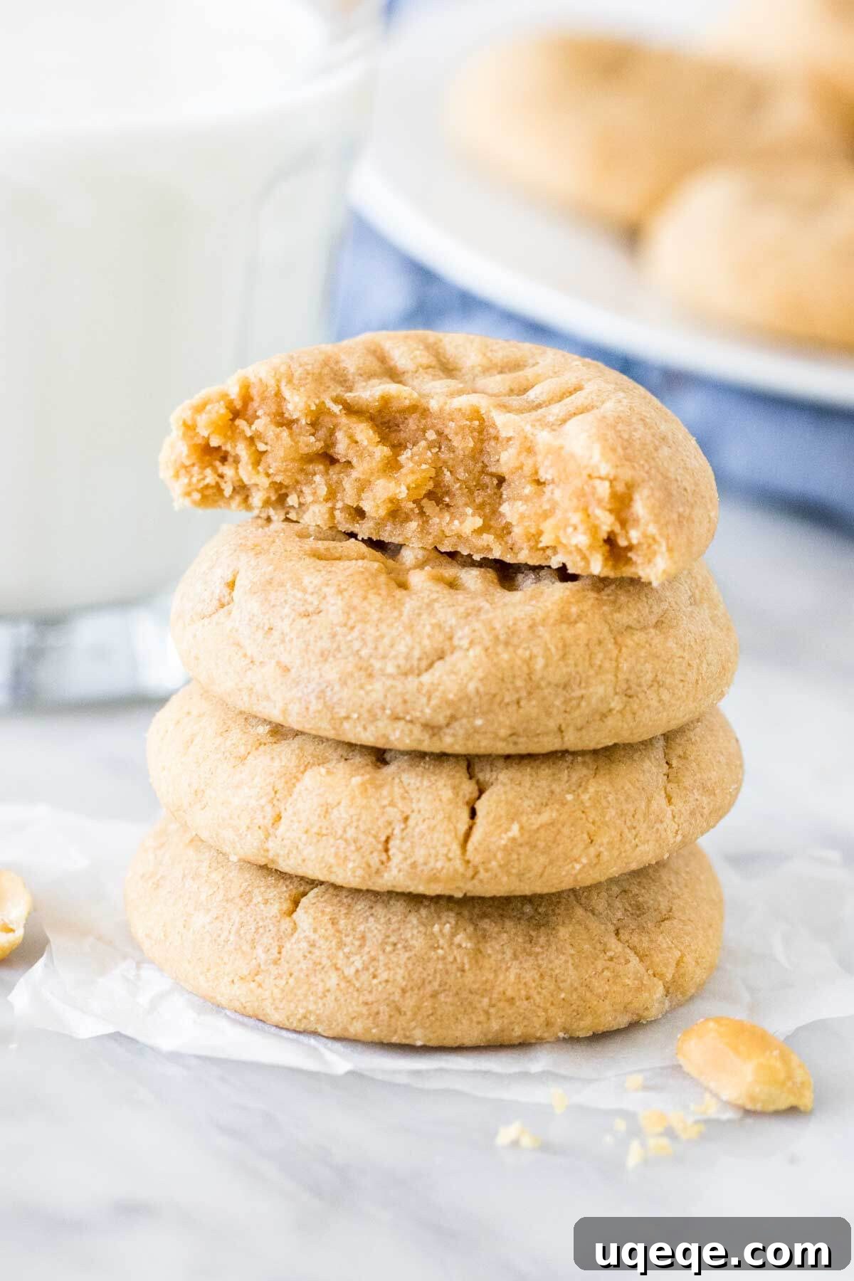 Effortless 3 Ingredient Peanut Butter Cookies 2 Stack of 4, three ingredient peanut butter cookies with the top cookie broken in half.