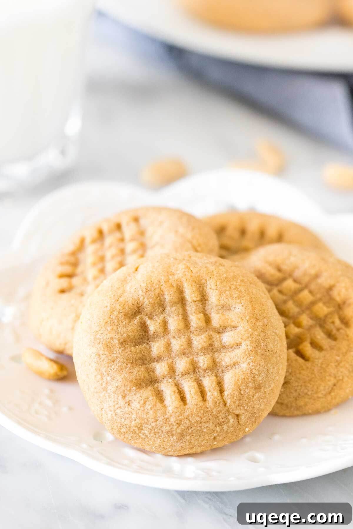 Effortless 3 Ingredient Peanut Butter Cookies 5 Small plate of 3 ingredient peanut butter cookies with a glass of milk.