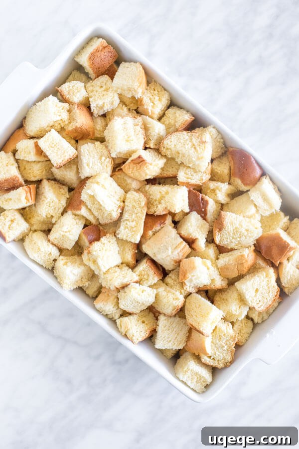 Overnight French Toast Bake 3 Casserole dish of bread cut into pieces to make French toast bake. Ready for the batter.