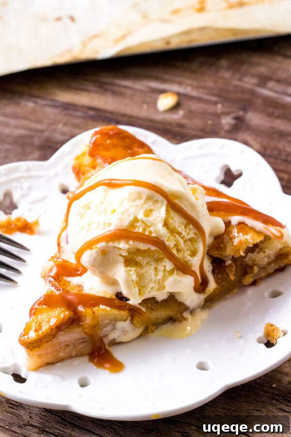 Rustic Caramel Apple Tart 6 A delectable slice of caramel apple galette with a scoop of vanilla ice cream, showcasing the tender apples and flaky crust, creating the ultimate apple dessert experience.