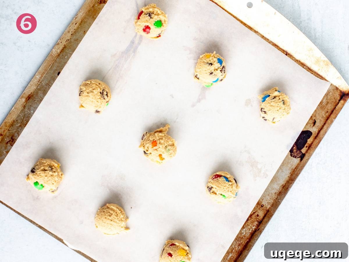 Irresistibly Soft Chewy M and M Cookies 6 Lined cookie sheet with M&M cookie dough balls
