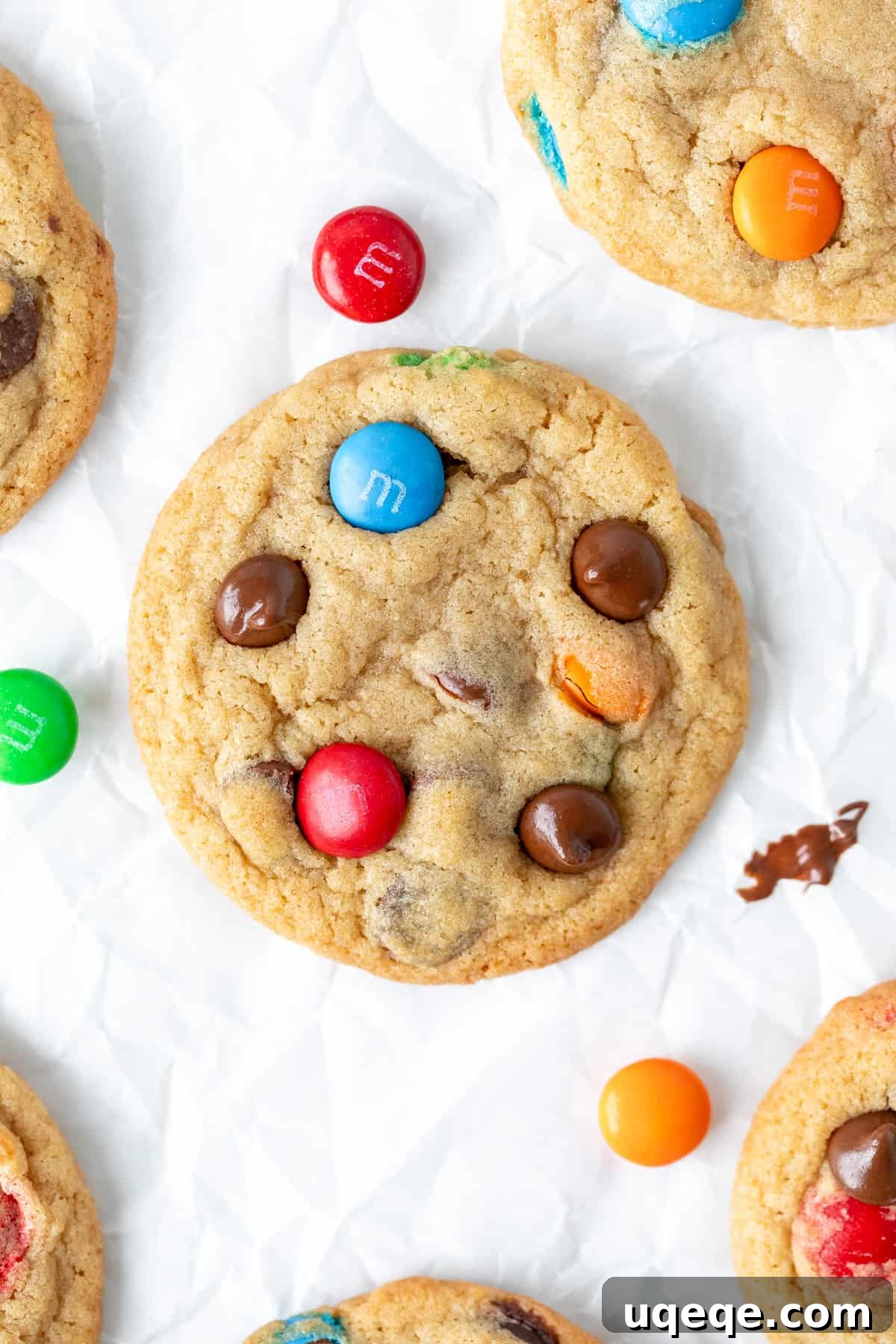 Irresistibly Soft Chewy M and M Cookies 7 Freshly baked M&M chocolate chip cookies cooling on baking paper, showcasing their perfect round shape and colorful candies.