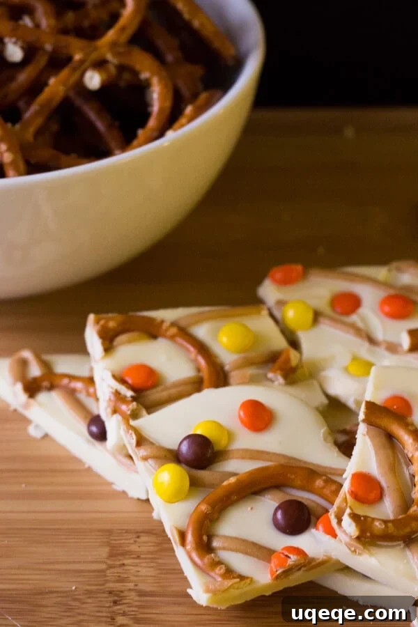 Halloween Peanut Butter Pretzel Crunch 2 Delicious Halloween Peanut Butter Pretzel Bark with pretzels, chocolate, and Reese's Pieces, perfect for parties.