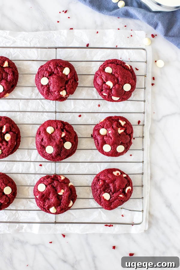 Red Velvet Cake Mix Delights 4 Cooling rack filled with freshly baked red velvet cookies studded with white chocolate chips.