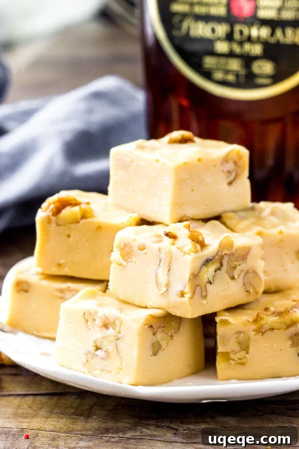 Golden Maple Walnut Delight 3 A close-up shot of creamy maple walnut fudge squares, highlighting the smooth texture and embedded walnuts.