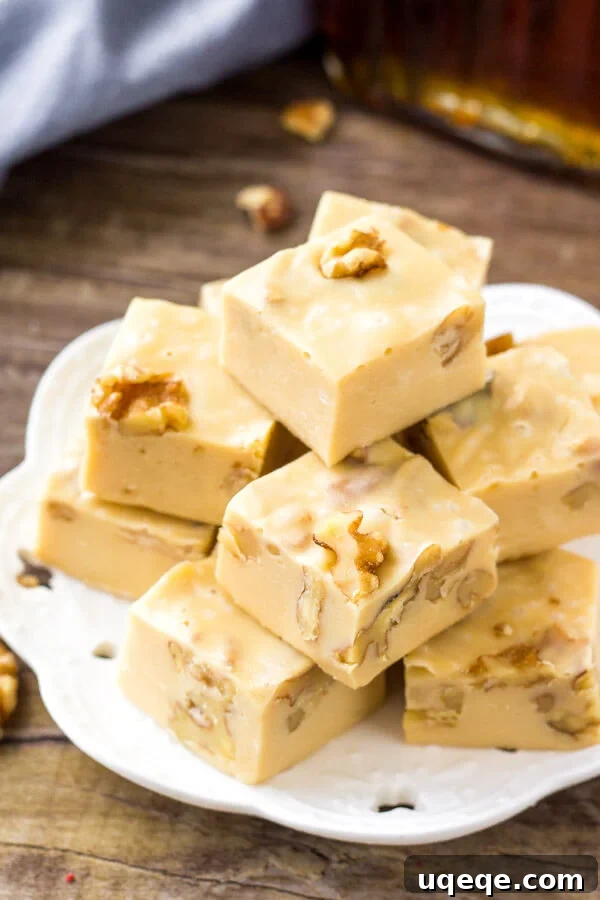 Golden Maple Walnut Delight 4 A plate of maple walnut fudge is the perfect easy Christmas candy recipe. The fudge is arranged neatly on a festive plate.