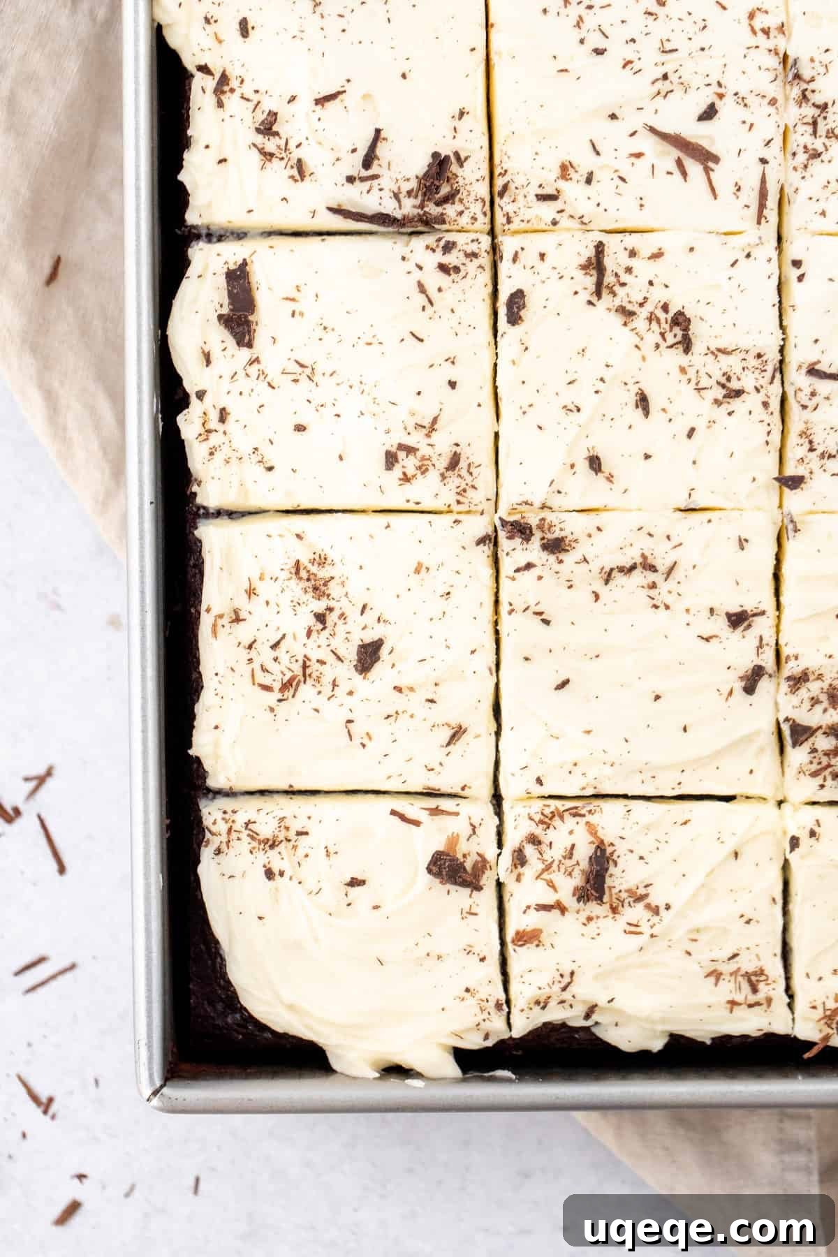 Velvet Chocolate, Cloud-White Topping 4 Sheet pan of chocolate cake with white chocolate frosting and chocolate shavings on top