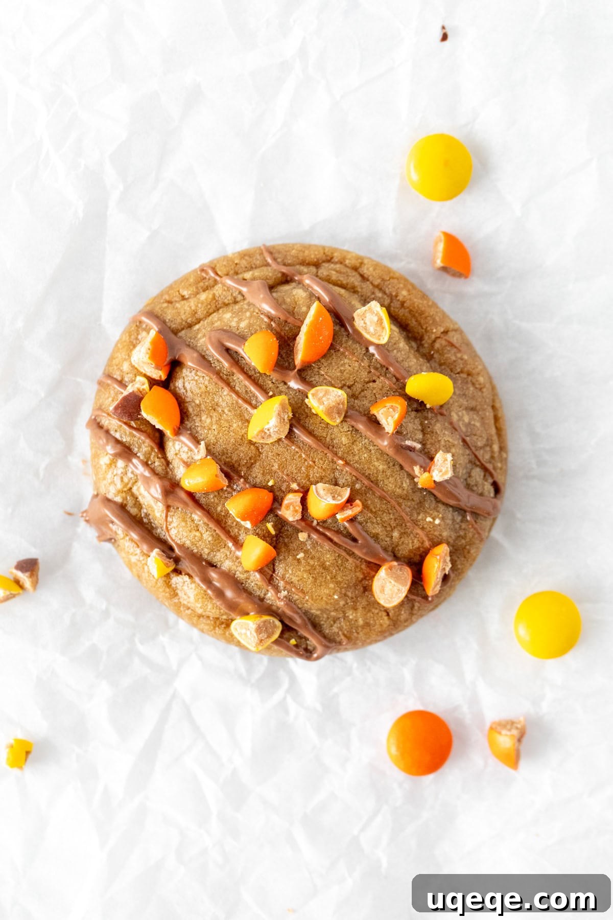 Reese's Peanut Butter Explosion Cookies 3 Peanut butter cookie with luscious milk chocolate drizzle and vibrant crushed Reese's Pieces on top, ready to be enjoyed