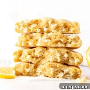 lemon white chocolate chip cookies, broken in half and stacked on top of one another