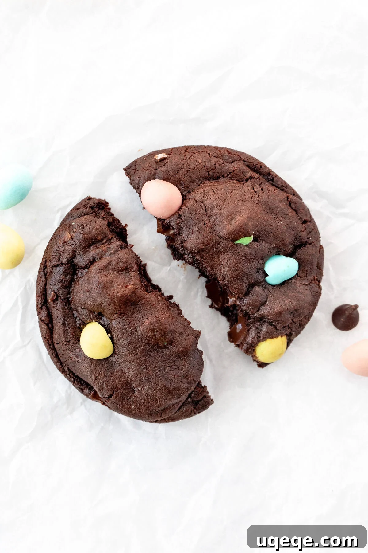 Delightful Mini Egg Chocolate Cookies 2 Mini Egg chocolate cookie, broken in half, showcasing its fudgy interior and colorful candy pieces