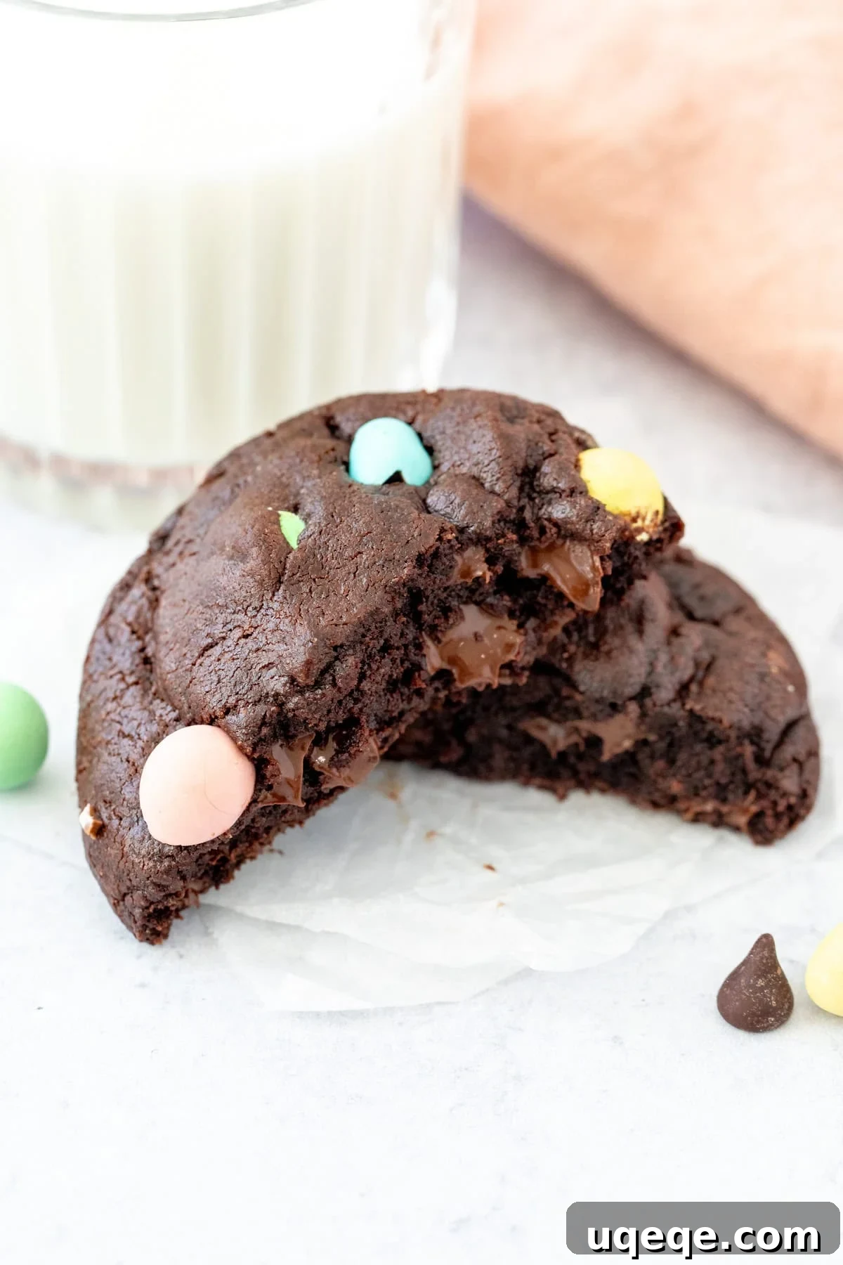 Delightful Mini Egg Chocolate Cookies 5 Chocolate mini egg cookie, broken in half with glass of milk, inviting a taste